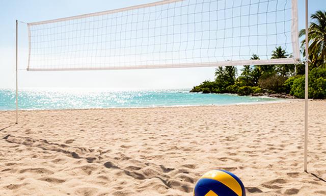 Portable beach volleyball net set up on firm South Florida sand