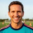 Coach Mike smiling in a soccer training shirt at a North Palm Beach youth clinic